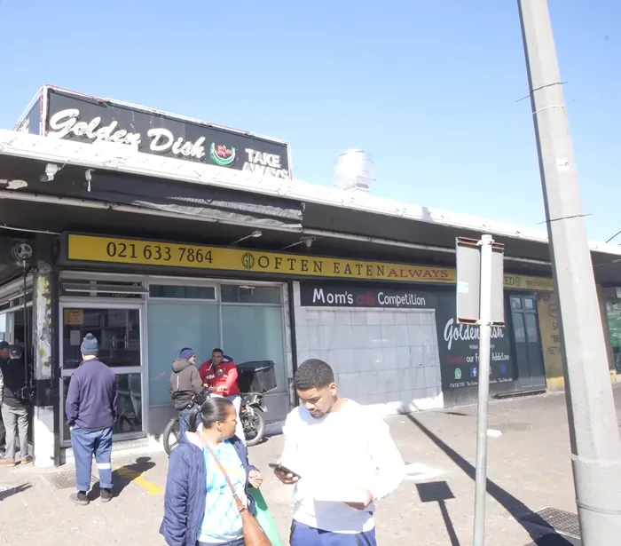 Customers at the corner of the Golden Dish in Gatesville, under the Often eaten, always remembered band
