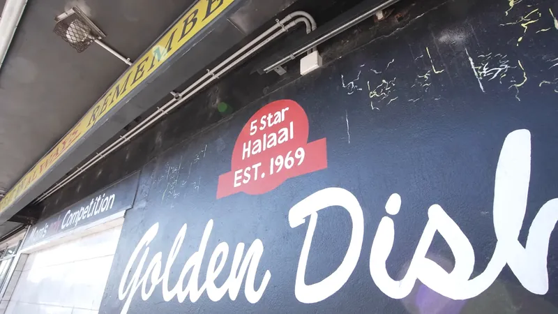 The painted side wall: 5 Star Halaal, Est. 1969, Golden Dish, and Mom's only Competition